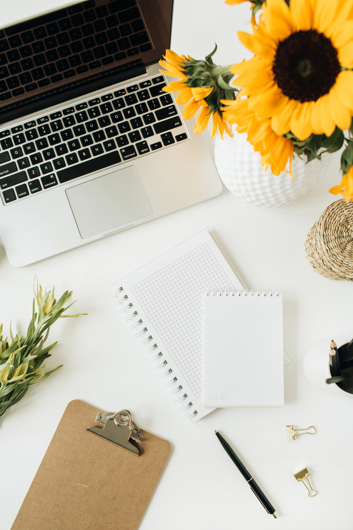 Table with Notebook, Laptop and Flowers